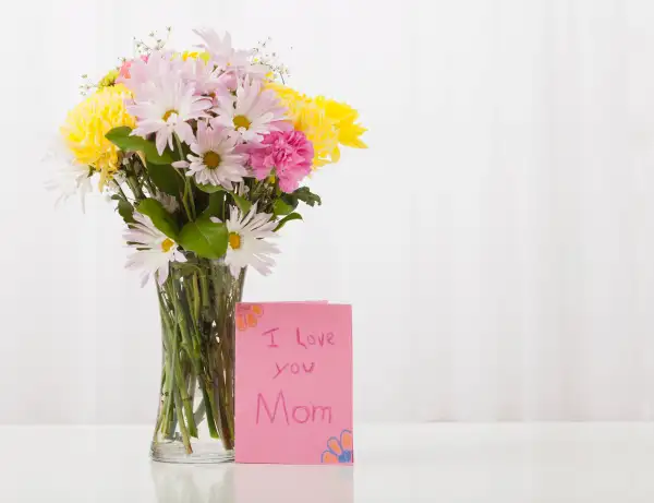 Bouquet in vase with greeting card for Mother's Day