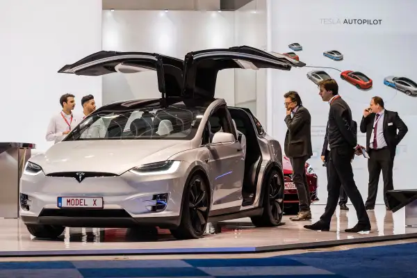Men look at the Tesla Model X during the media day of the 95th European Motor Show in Brussels on Jan. 13, 2017.