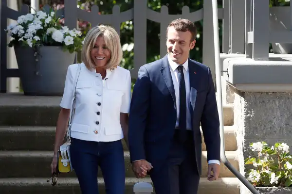 French President Emmanuel Macron and his wife Brigitte Macron leave their house in Le Touquet, northern France, before casting their votes in the first round of the two-stage legislative elections, Sunday, June 11, 2017.