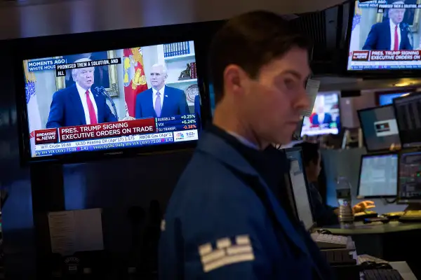 President Donald Trump is displayed on television monitors as traders work and financial professionals work on the floor of the New York Stock Exchange (NYSE) ahead of the closing bell, March 31, 2017 in New York City.