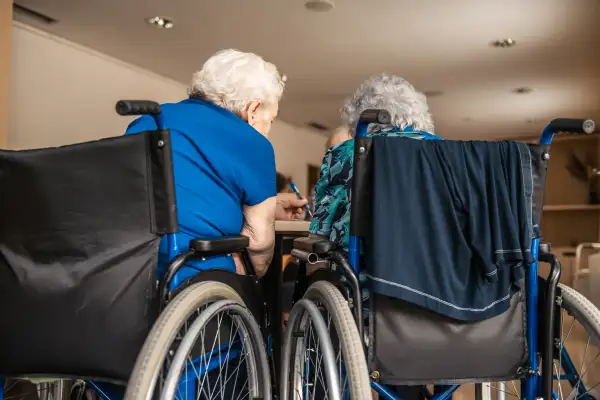 Seniors On The Wheelchair In The Nursing Home Waiting For The Therapy In The Gym Class