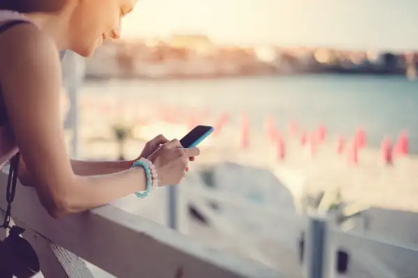 Girl at a veranda text messaging on the phone