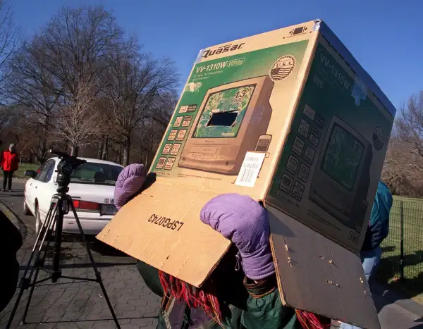 Wendy Shifrin of South Lee, MA. uses a box fitted with welder's glass to view a partial solar eclipse in New York's Central Park on Christmas day, Monday, Dec. 25, 2000.