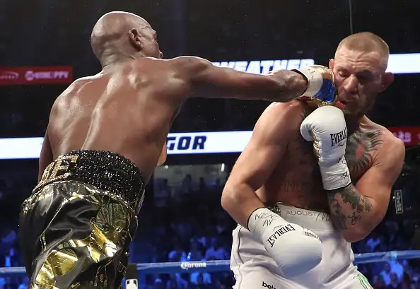 Floyd Mayweather Jr. throws a punch at Conor McGregor during their super welterweight boxing match on August 26, 2017 at T-Mobile Arena in Las Vegas, Nevada.