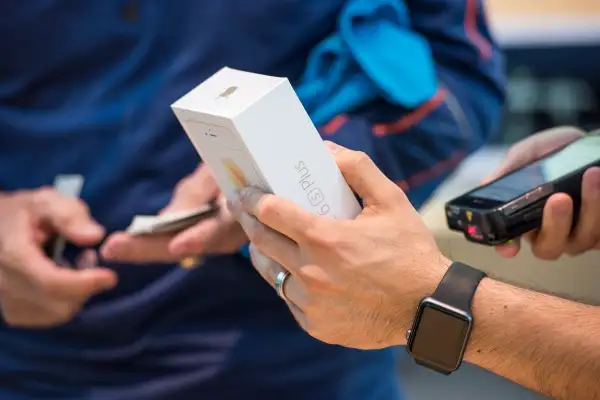 An employee scans a new Apple Inc. iPhone 6s Plus at an Apple store in Palo Alto, California, on Sept. 25, 2015.