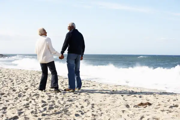 Senior couple walking beach together