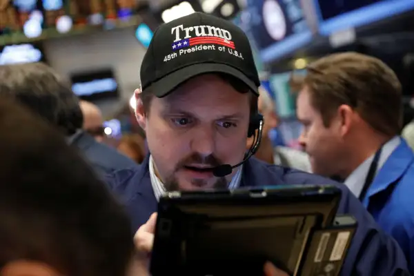 A trader wears a Donald Trump hat while working on the floor of the NYSE shortly after the opening bell in New York