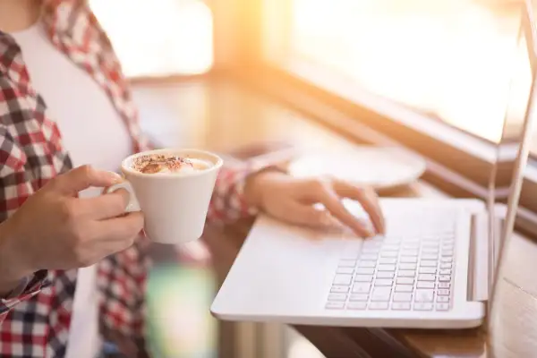 Woman in cafe drinking coffee, having brake from work