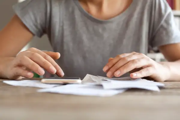 Woman hands with bills and mobile phone