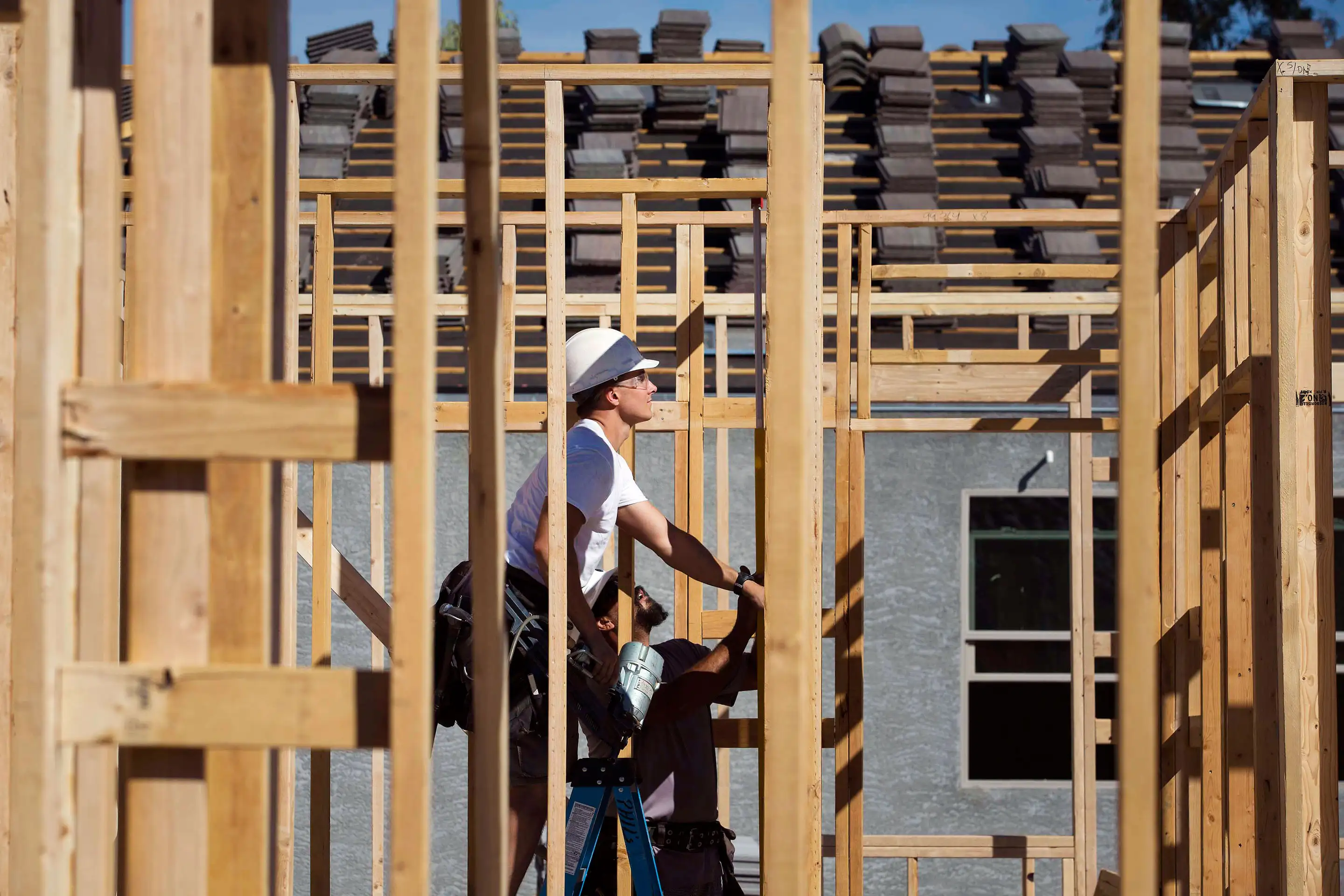 Contractors work on the frame of a home under construction at the D.R. Horton Express Homes Magma Ranch development in Florence, Ariz.