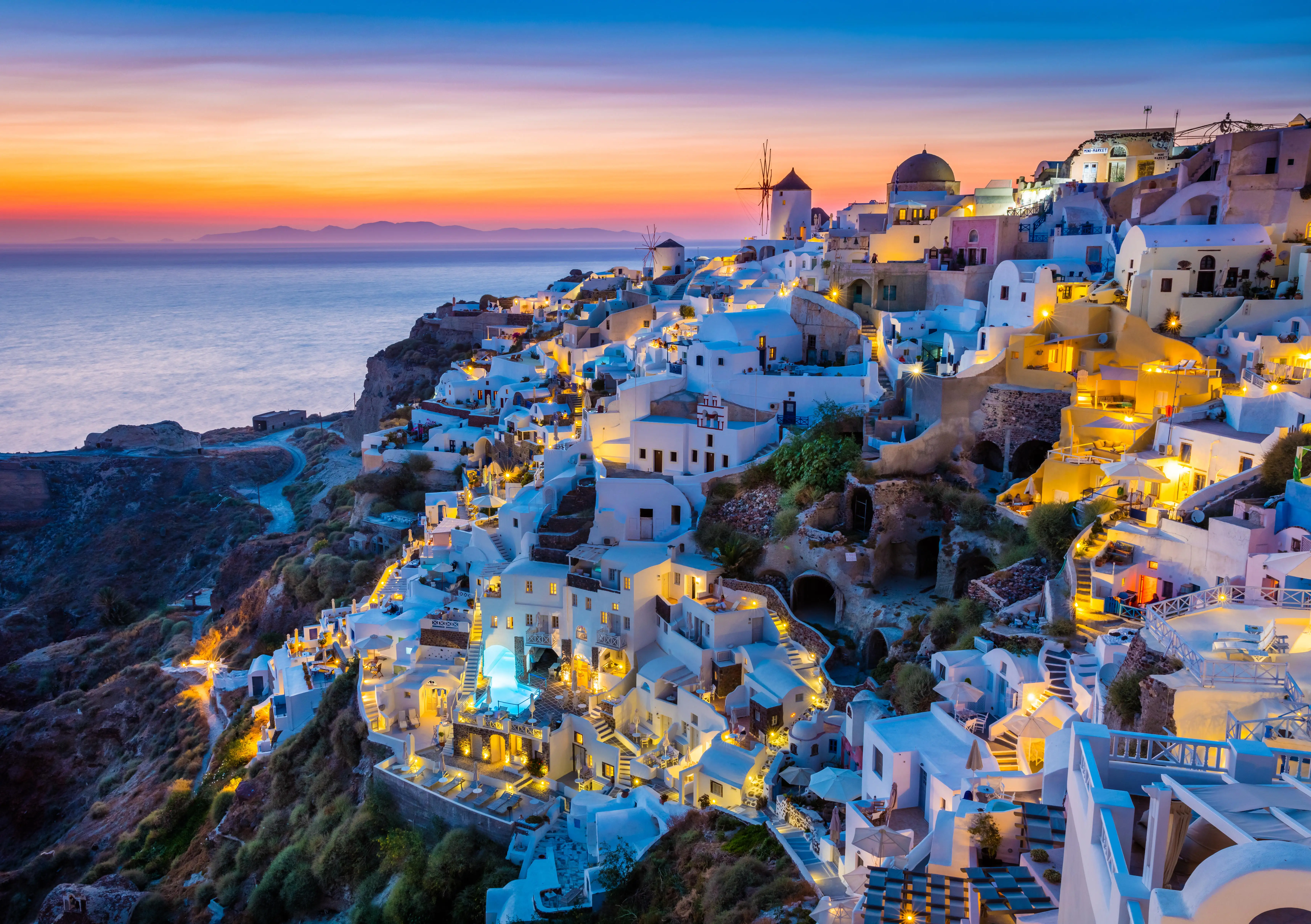 Iconic sunset in the town of Oia on the greek island Santorini (Thera).