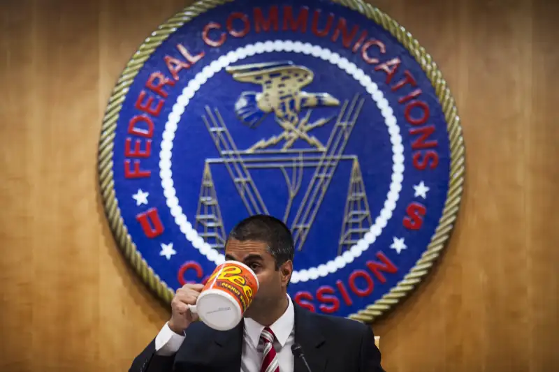 The Federal Communications Commission Holds Open Meeting Reconsidering Broadcast Ownership Rules Ajit Pai, chairman of the Federal Communications Commission (FCC), drinks from an oversized coffee mug during an open meeting in Washington, D.C., U.S., on Thursday, Nov. 16, 2017. The FCC plans to vote in December to kill the net neutrality rules passed during the Obama era. Photographer: Zach Gibson/Bloomberg via Getty Images