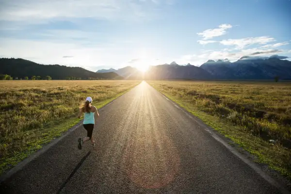 A female running at sunset.