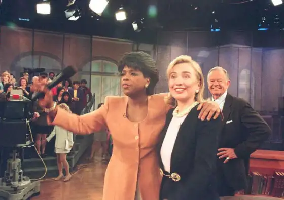 US First Lady Hillary Clinton (R) stands with tele