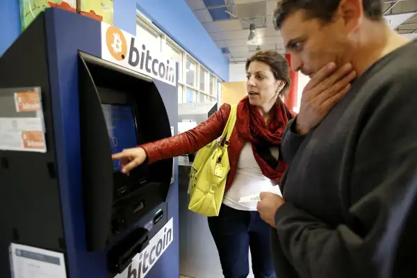 Hami Oerner and Itzik Lerner, right, learn how to use a new bitcoin ATM machine at Hacker Dojo in Mountain View, Calif., April 1, 2014. Robocoin is California's first permanent 24/7 bitcoin ATM machine. (Gary Reyes/Bay Area News Group/MCT)