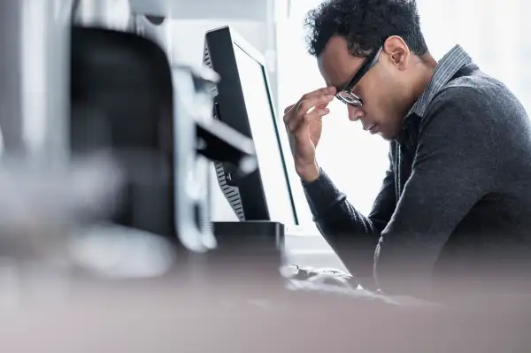 Tired man sitting in office