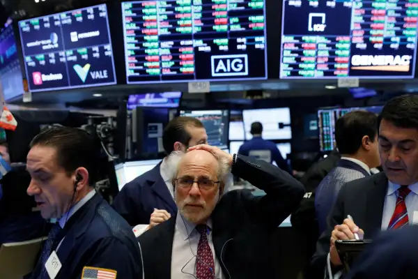 Traders work on the floor of the New York Stock Exchange shortly after the opening bell in New York