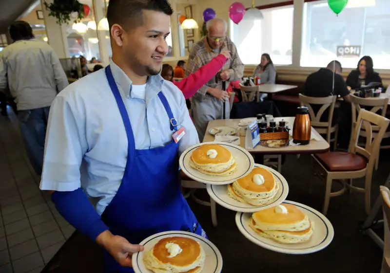 Server Ruben Avalos performs a balancing act with several plates of the free pancakes. The International House of Pancakes hosts a National Pancake Day at its restaurants across the country on Tuesday, Mar.1, 2011. By serving each patron a free short stac Tuesday is National Pancake Day at IHOP, when all customers get a free short stack of pancakes.