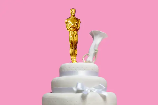 Oscar statuette on top of wedding cake with bride upside down