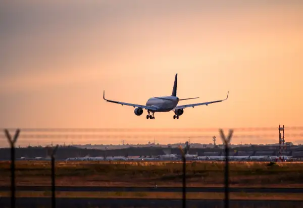 Airplane landing at sunset