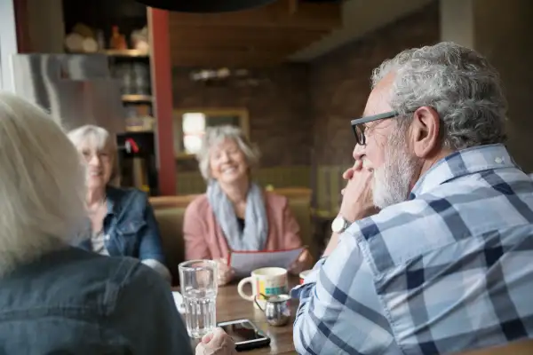 Senior friends dining in diner booth