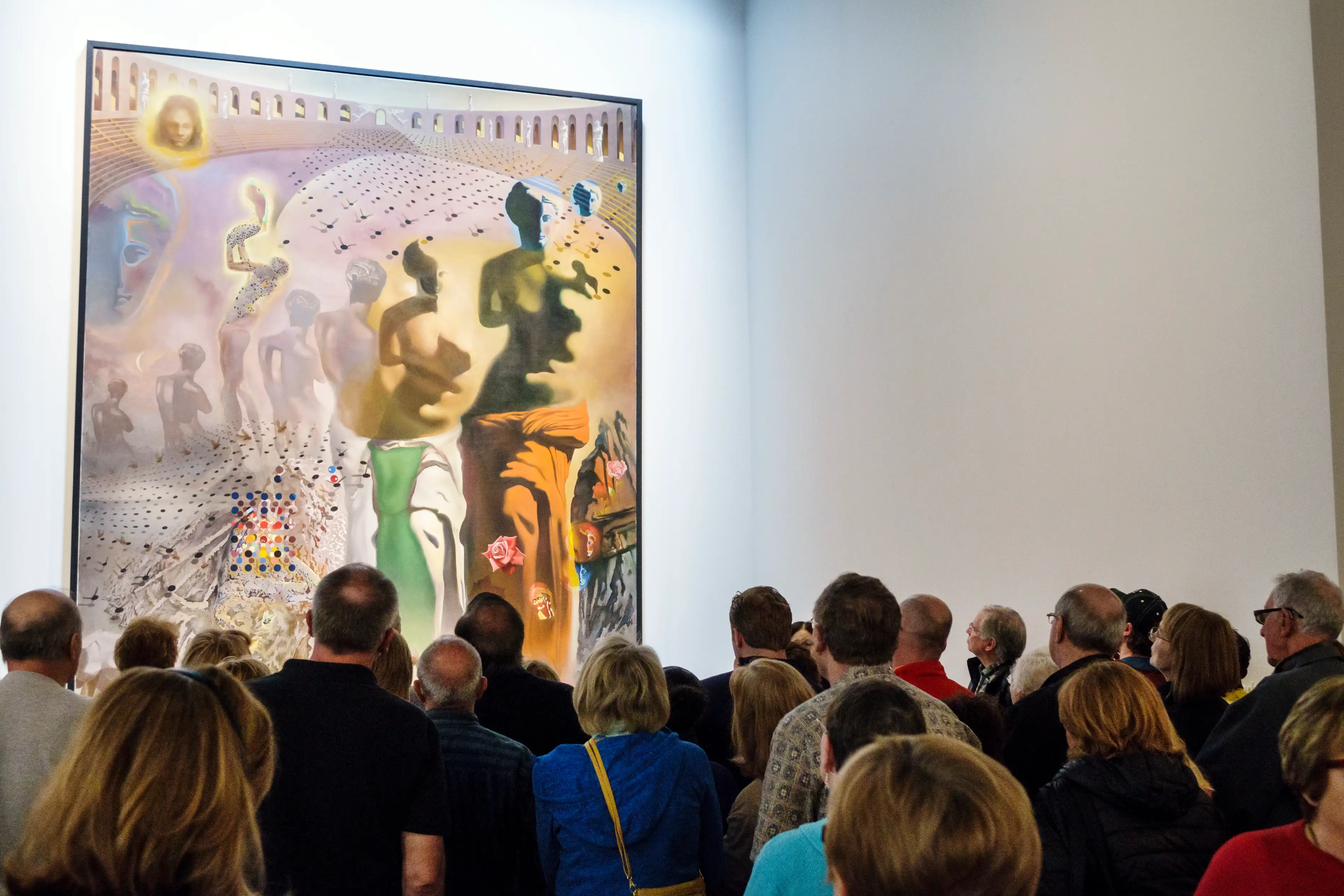 A guide explaining the Hallucinogenic Toreador painting inside the Salvador Dali Museum.