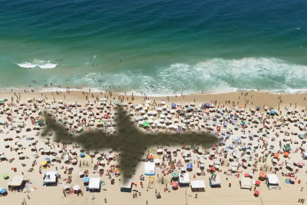 A plane flies over a beach near Rio de Janeiro, Brazil, November 15, 2013.