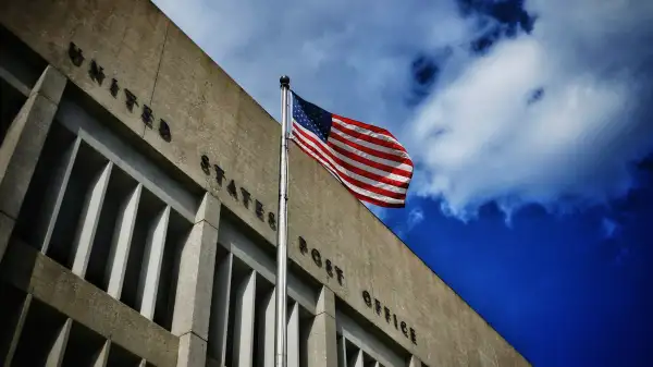 Low Angle View Of Post Office Against Blue Sky