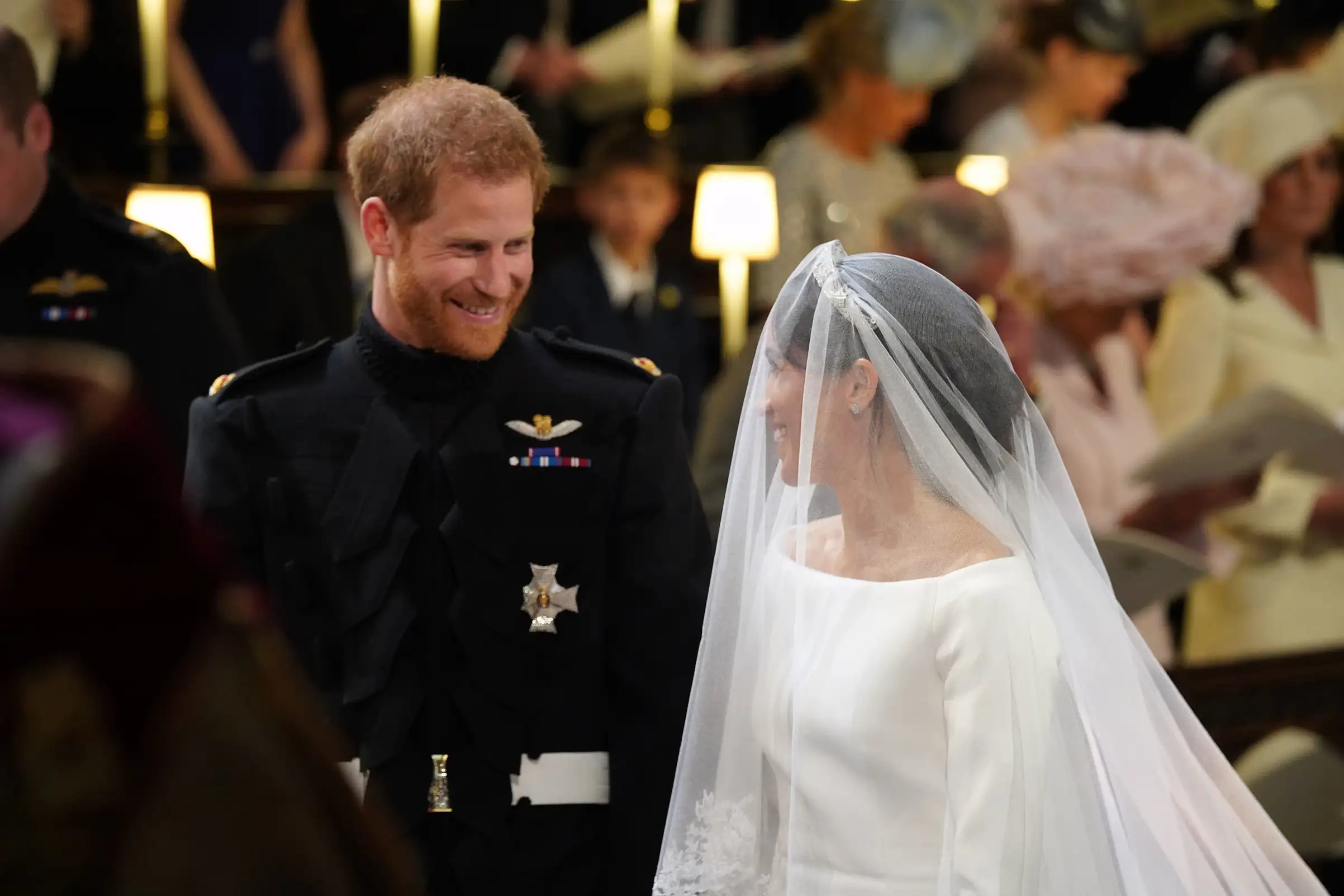 Prince Harry looks at Meghan Markle, as she arrives accompanied by the Prince of Wales in St George's Chapel at Windsor Castle, May 19, 2018.