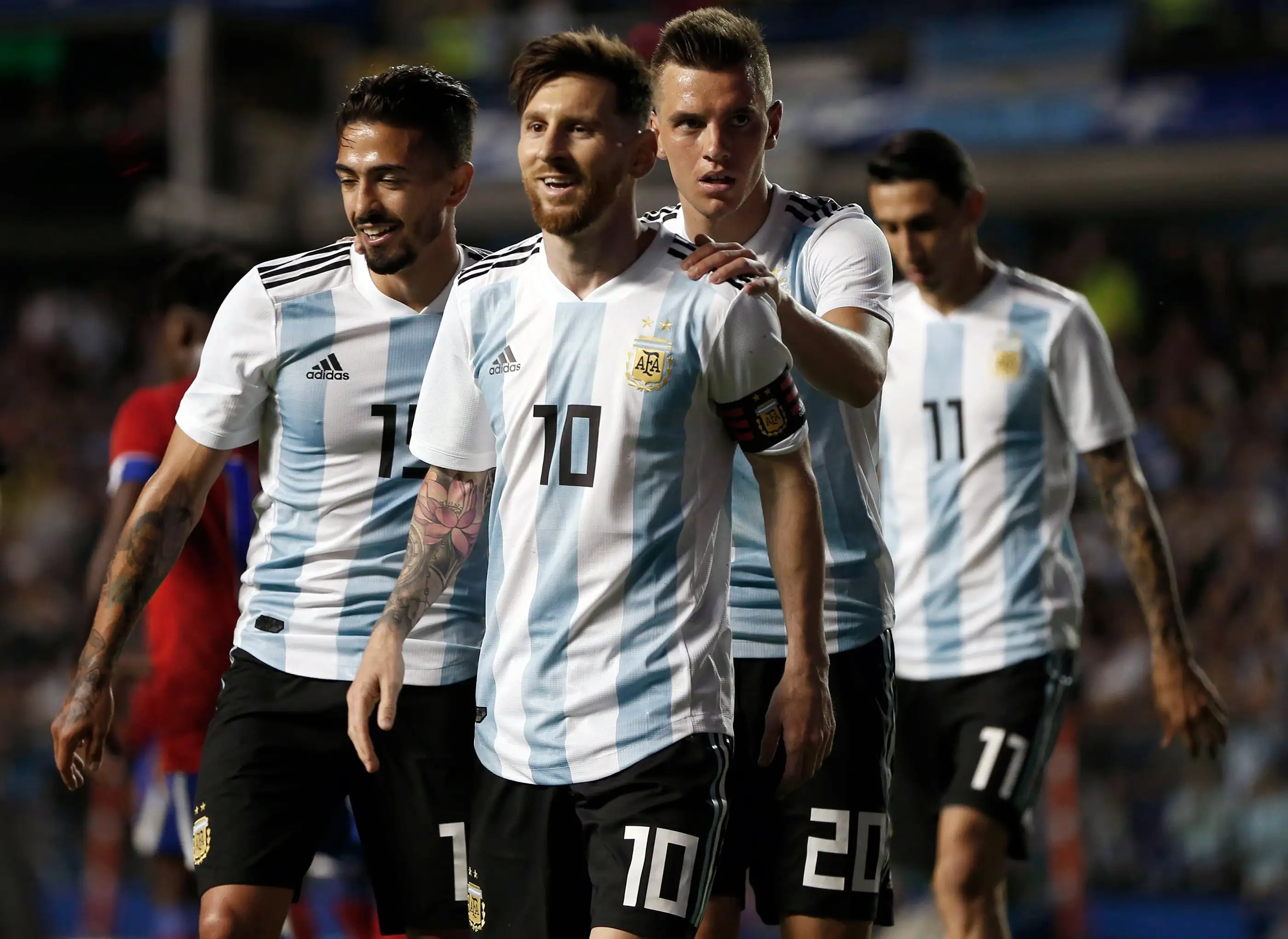 Argentina's Manuel Lanzini, left, Giovanni Lo Celso, second right, and Angel Di Maria, right, congratulate teammate Lionel Messi, second left, after his hat trick during a friendly soccer match between Argentina and Haiti at the Bombonera stadium in Buenos Aires, Argentina, May 29, 2018.