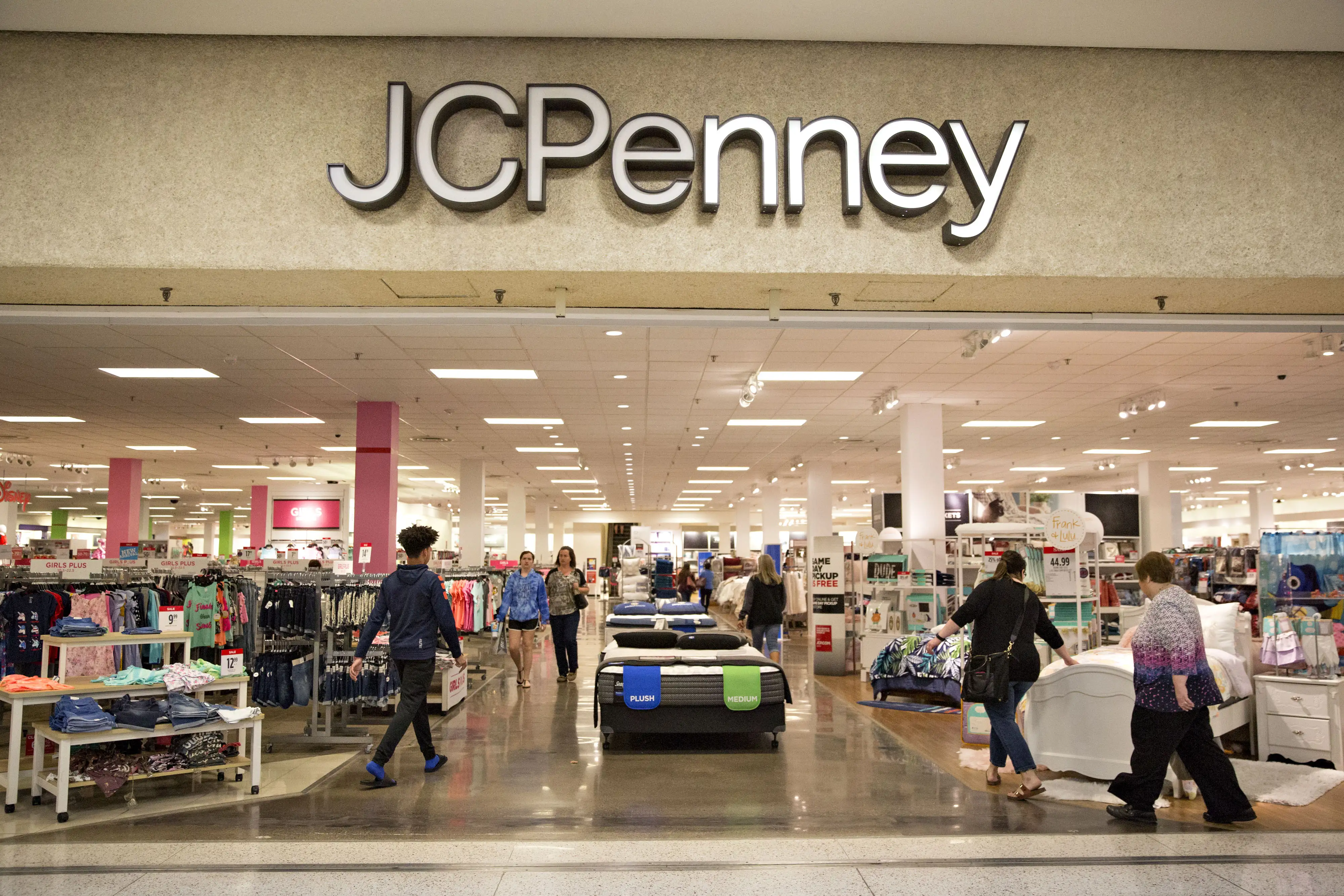 Shoppers enter a J.C. Penney Co. store in Peoria, Illinois, U.S., on Saturday, May 12, 2018.
