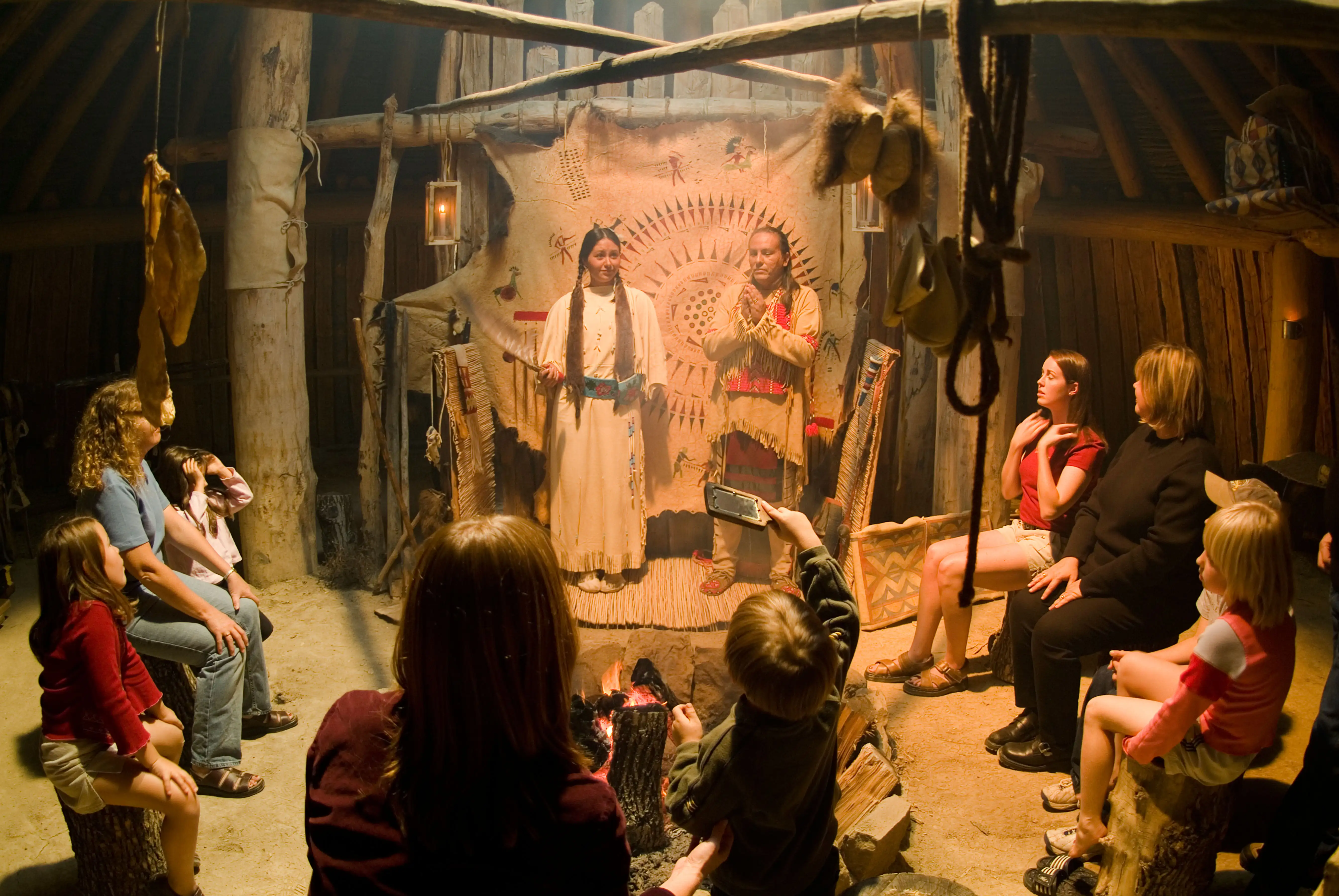 Native American Indians in an Earth Lodge at the On A Slant Village at Fort Abraham Lincoln State Park North Dakota