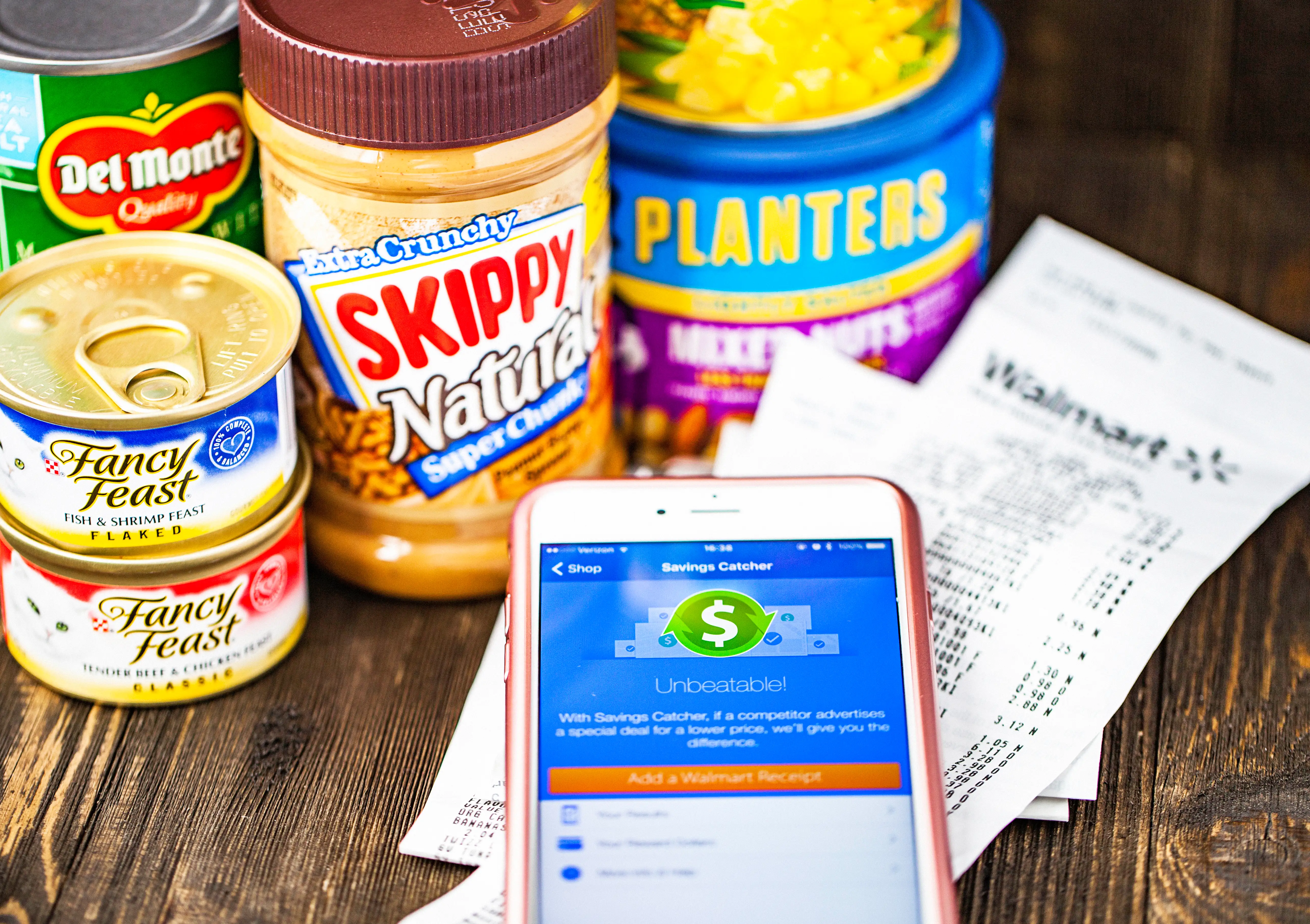 Walmart Savings Catcher App on iPhone screen and assorted groceries