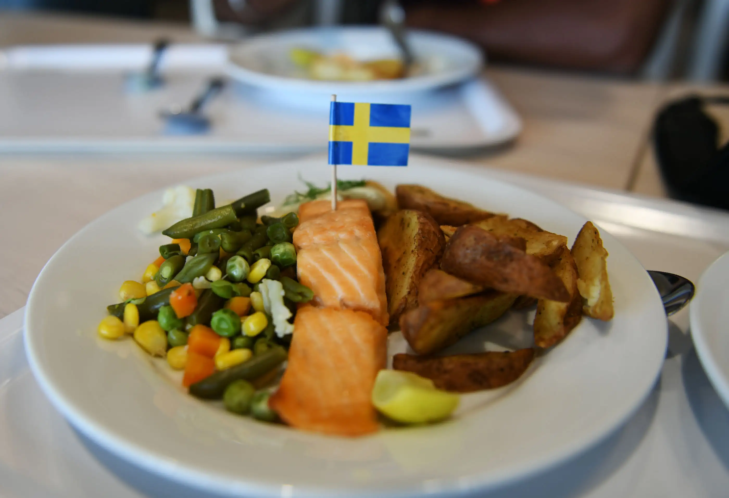 The Swedish national flag is seem placed on a plate of food at the restaurant section the new IKEA store in Hyderabad on August 8, 2018.