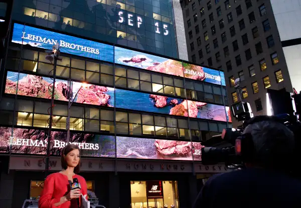 A journalist reports outside the Lehman Brothers building in New York