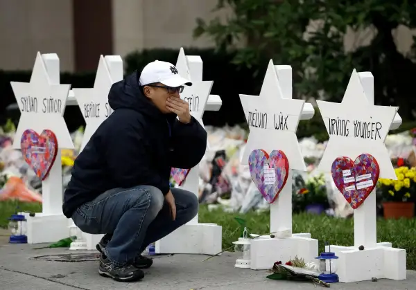 A person pauses in front of Stars of David with the names of those killed in a deadly shooting at the Tree of Life Synagogue, in Pittsburgh, October 29, 2018.