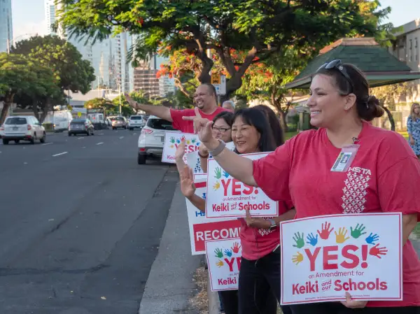 Teachers from McKinley High School on Oahu sign waved to motorists before school in October 2018.