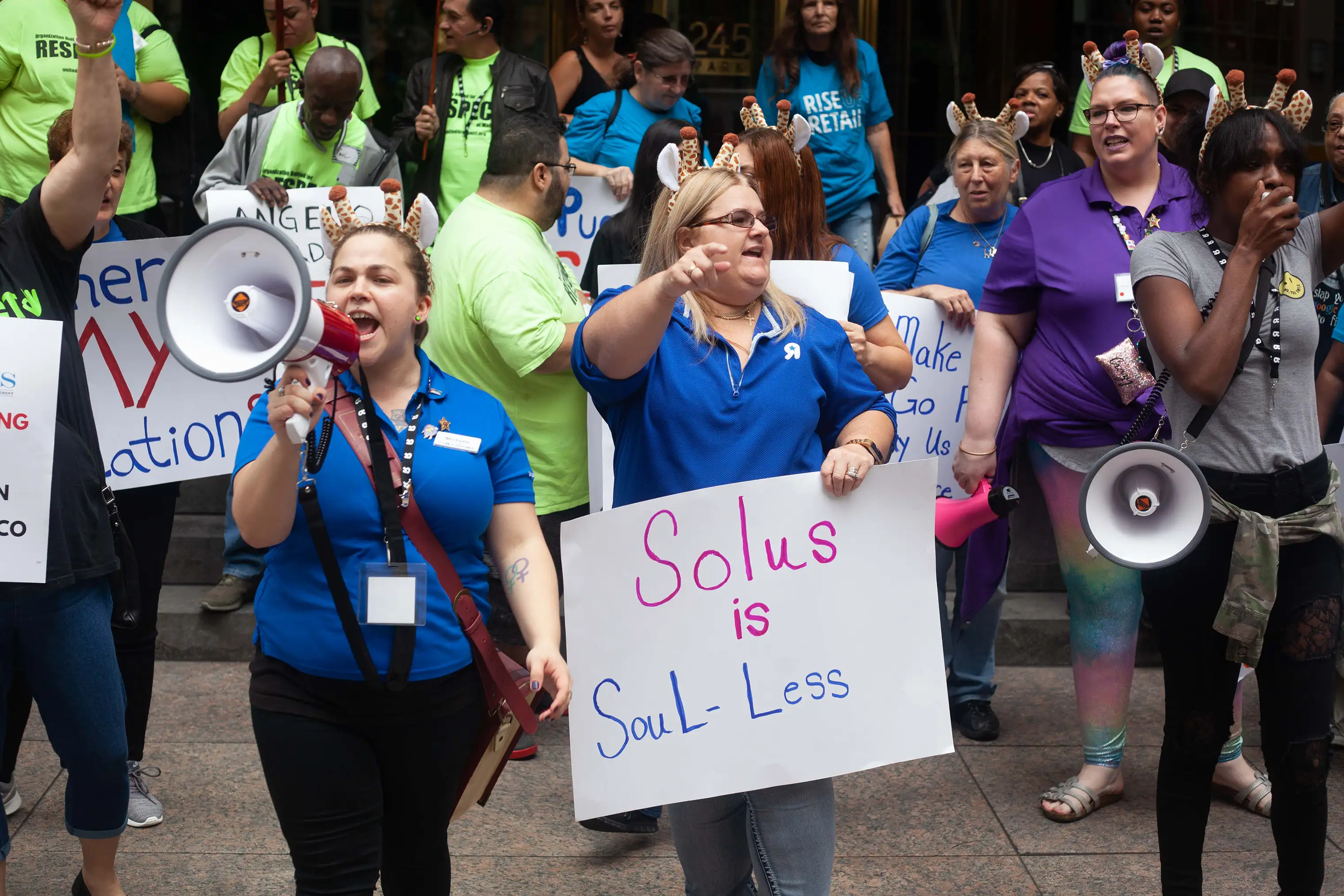 Cheryl Claude (center) and Sarah Woodhams (in purple) participate in a joint action by Organization United for Respect (OUR) Walmart leaders and Rise Up Retail leaders to protest Angelo Gordon and Solus Alternative Asset Management on Oct. 9, 2018, in NYC.