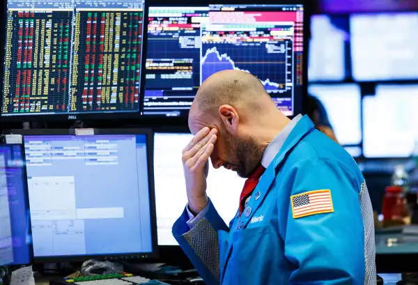 A trader works on the floor of the New York Stock Exchange at the closing bell in New York, New York, USA, on 04 December 2018.