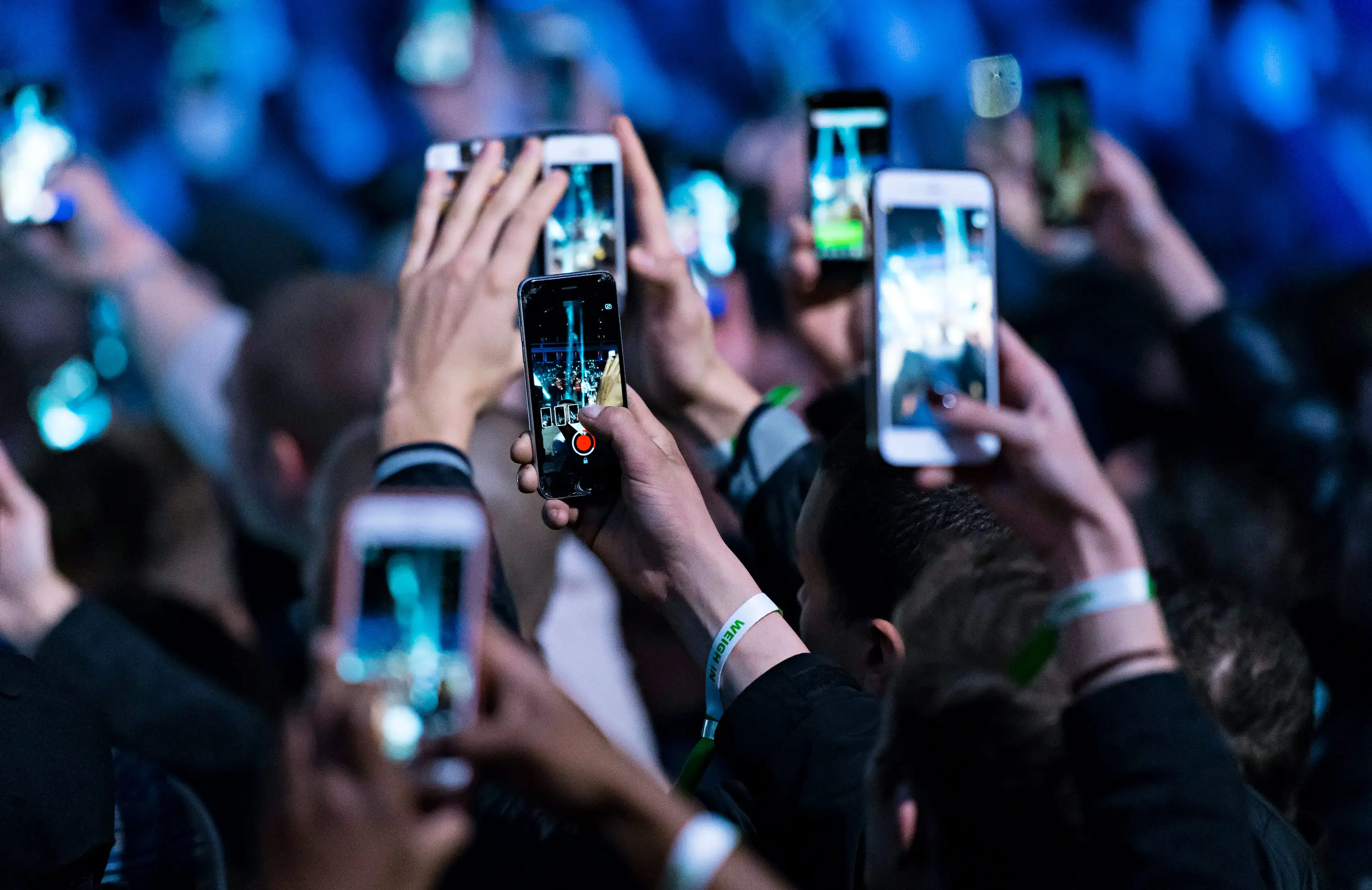 Spectators use their Apple iPhones at an event in Cardiff, United Kingdom.