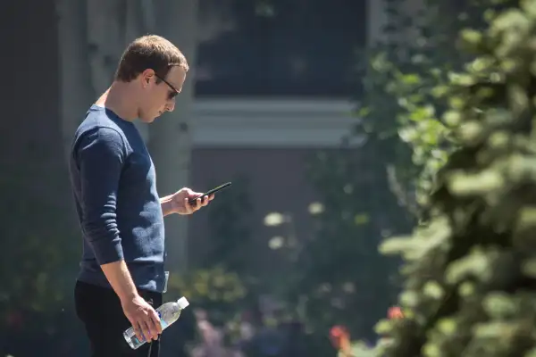 Mark Zuckerberg, chief executive officer of Facebook, checks his phone during the annual Allen and Co. meeting In Sun Valley, Idaho, July 13, 2018.