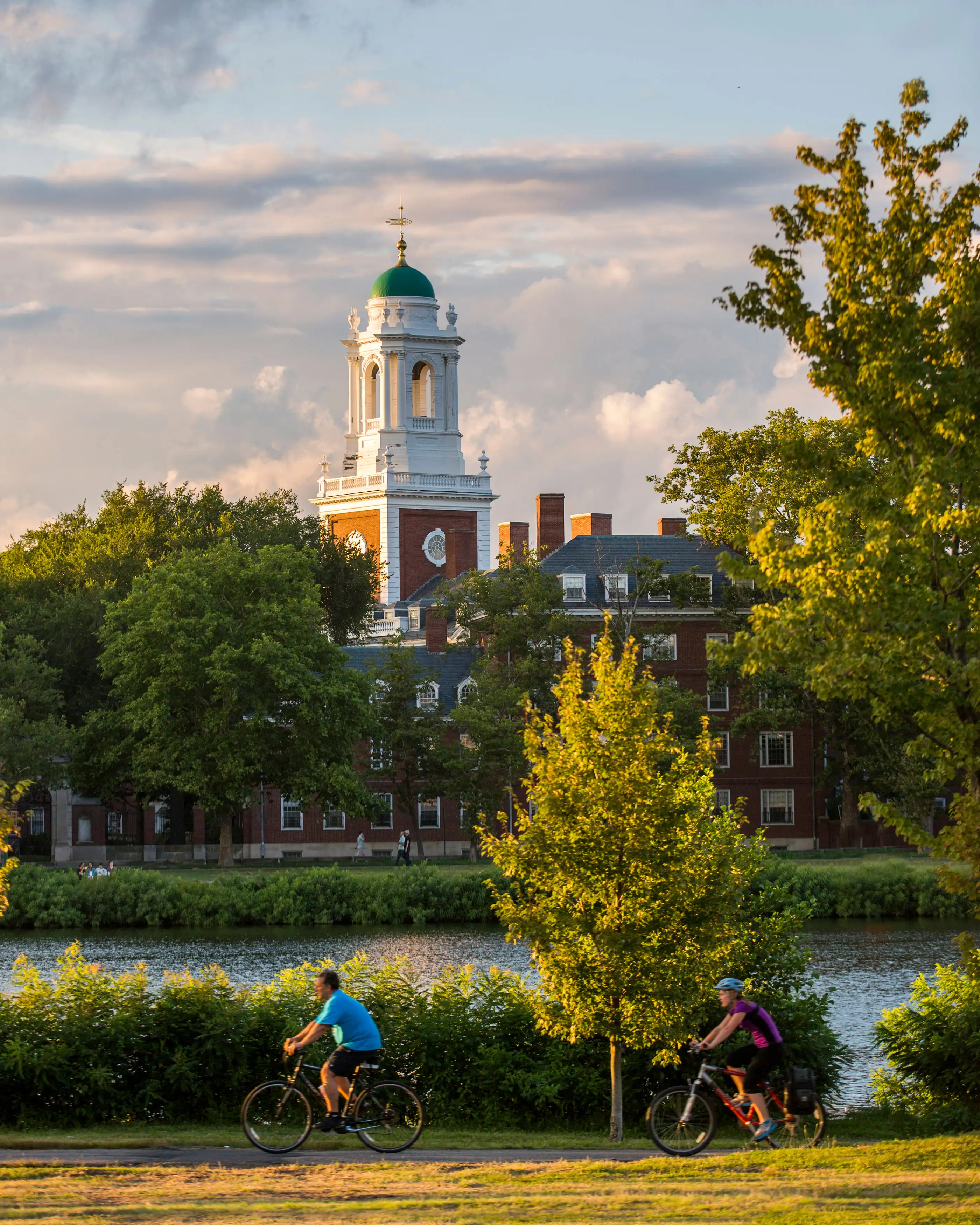 Bicyclists along the Charles River in Cambridge, MA near Harvard University.