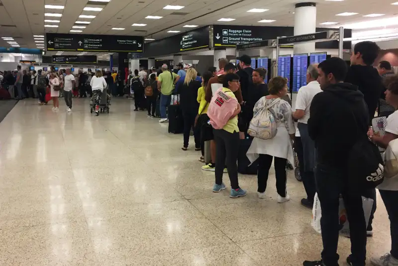 US-POLITICS-SHUTDOWN-TRANSPORT-AVIATION-MIAMI Passengers flying from Miami International Airport wait in line to enter the checkpoint at Concourse F, where some of the flights of a closed terminal were diverted, on January 13, 2019.