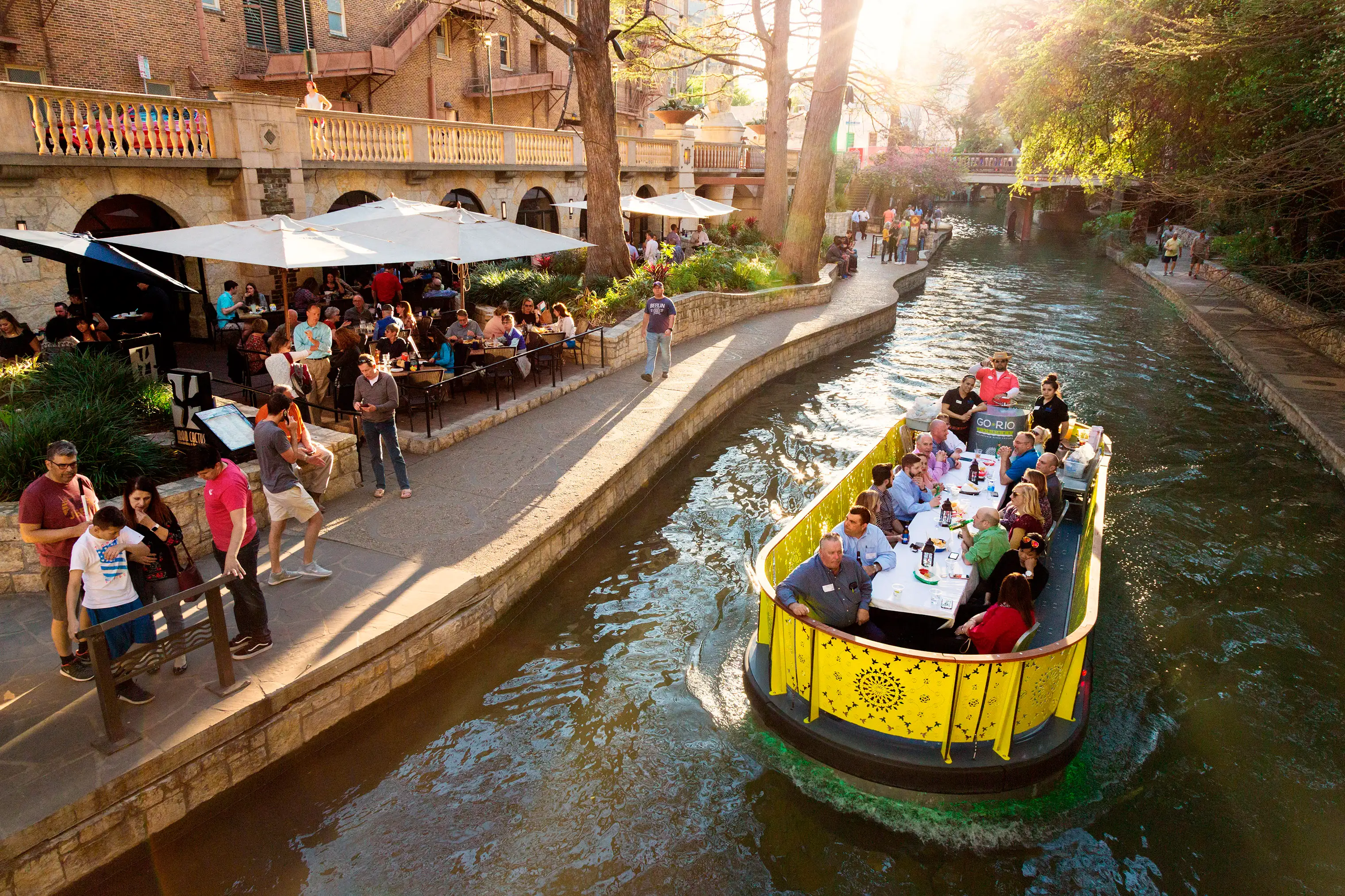 Travelers can dine on a barge and enjoy the San Antonio River Walk