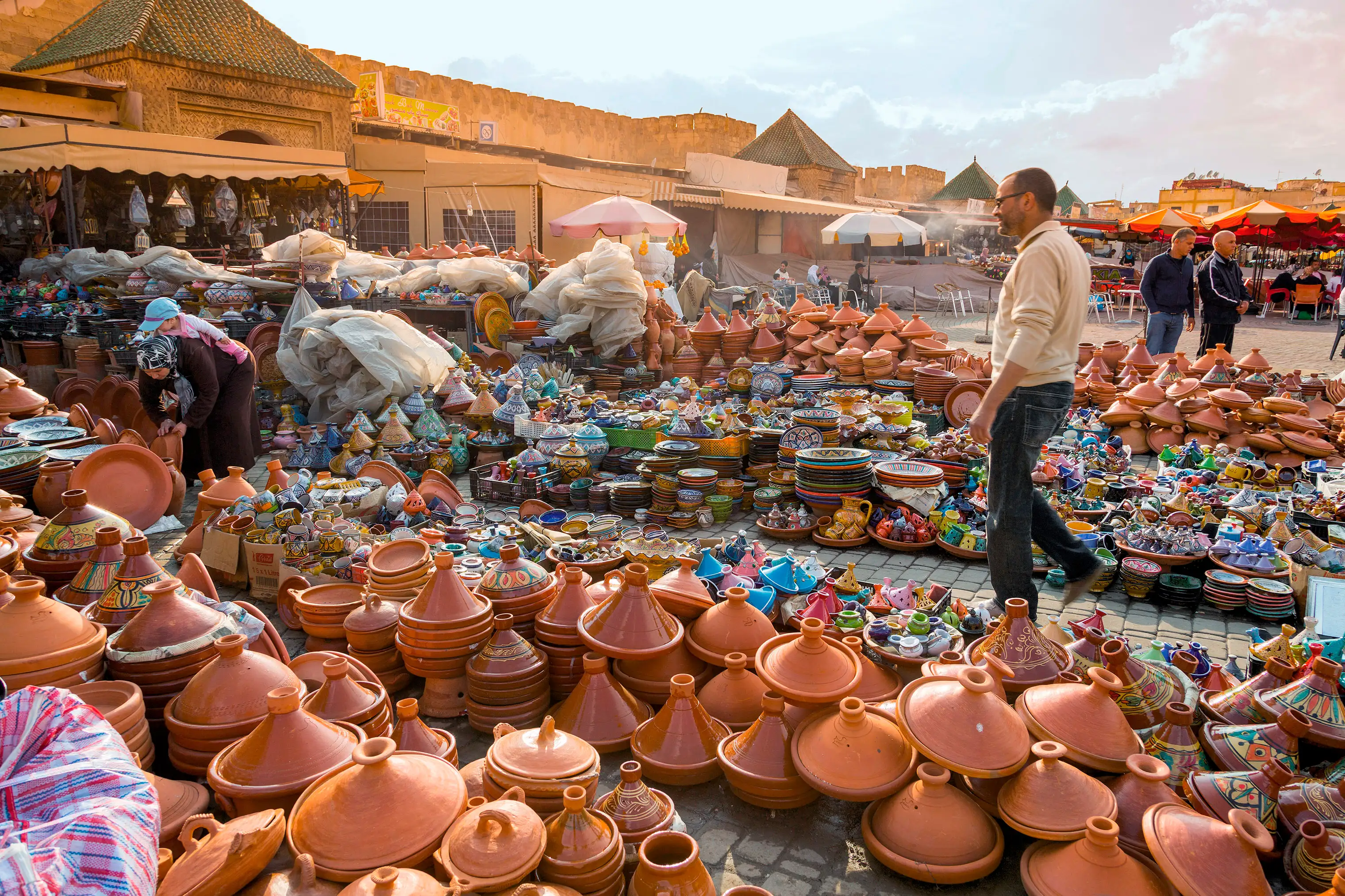 Traditional tagine pots are sold in the Meknes souks (left); ancient mosaics decorate the nearby ruins of Volubilis.