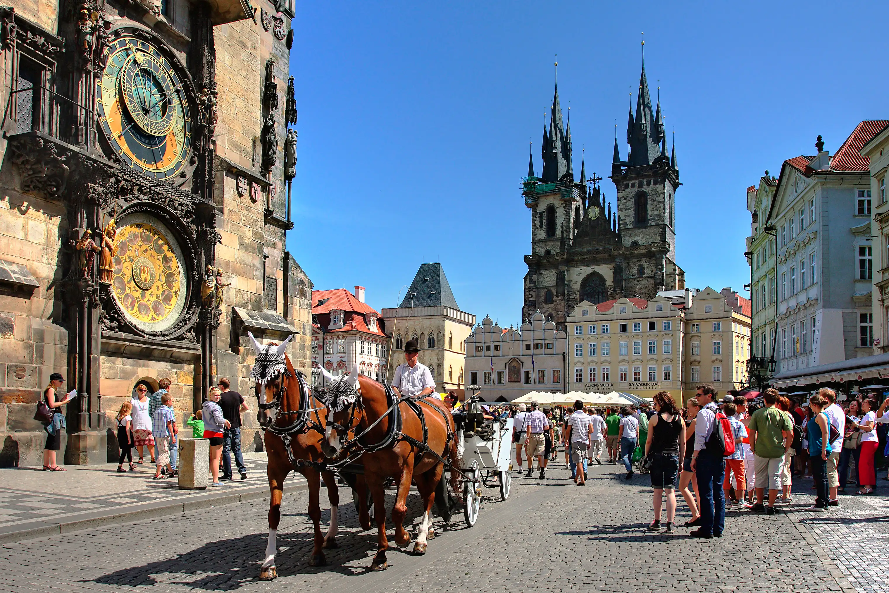 A carriage passes by the historic Old Town Square in Prague.