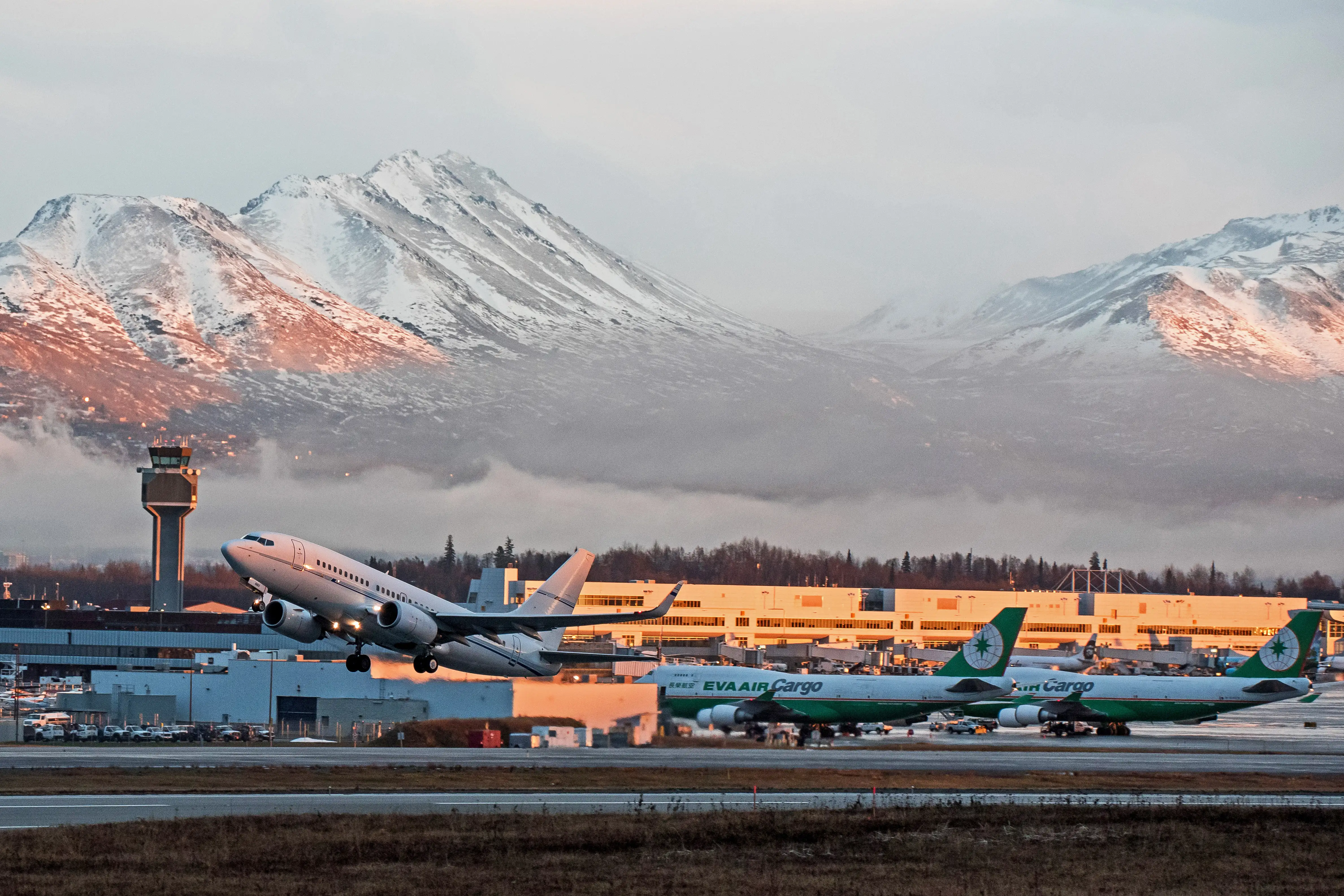 Aircrafts depart from Ted Stevens Anchorage International Airport at sunset, Anchorage, Alaska