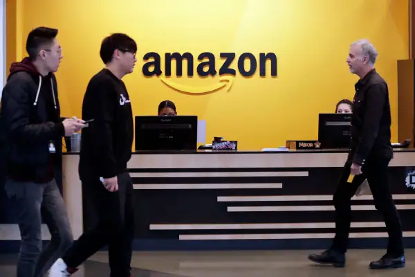 Employees walk through a lobby at Amazon's headquarters, in Seattle. Amazon, November 13, 2018.