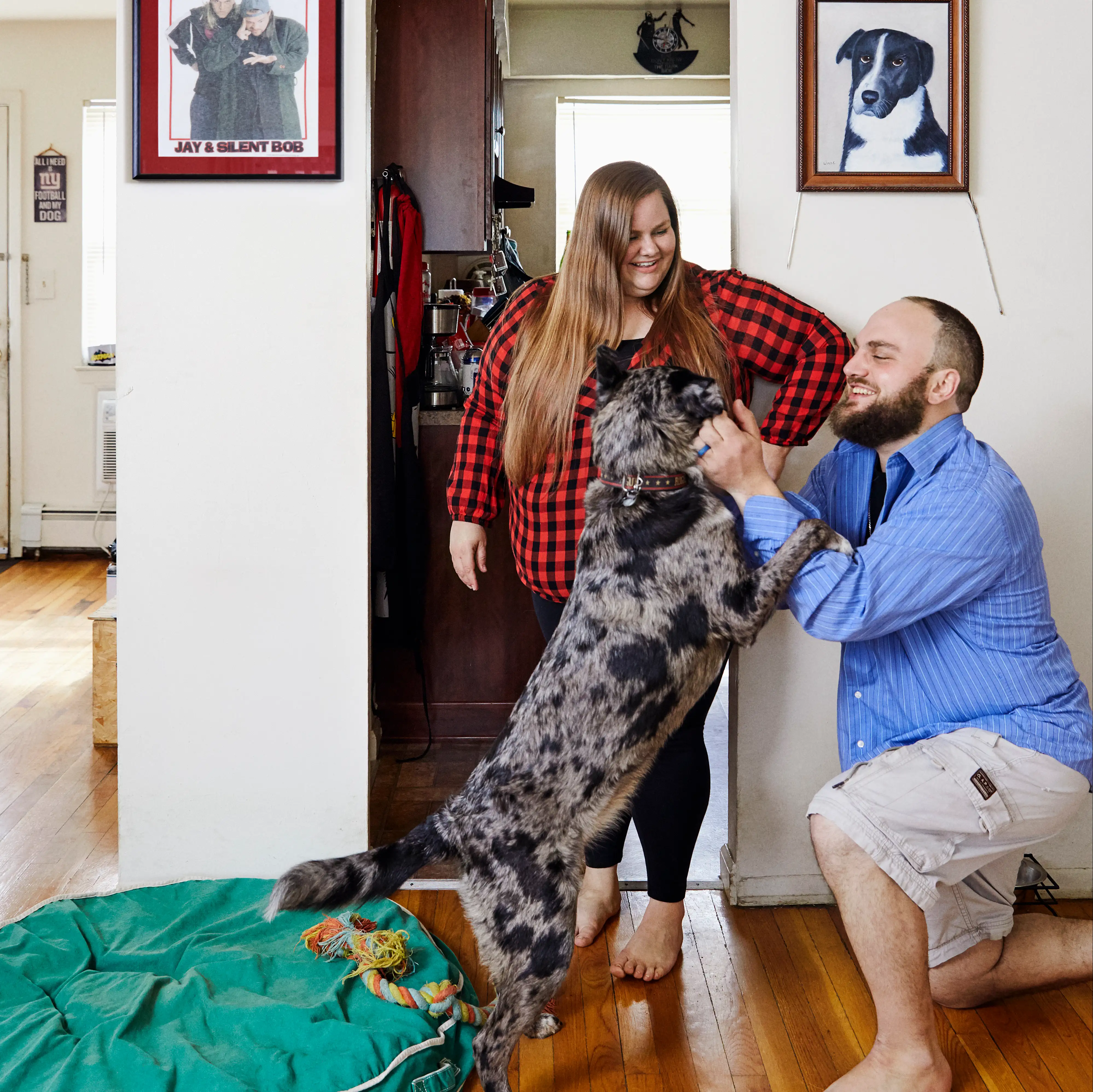 KC and Ryan in their house with their dog