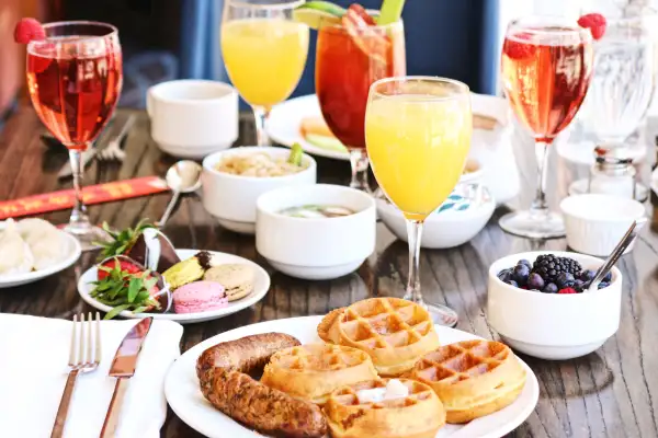 Waffles, sausage, and Mimosa Brunch
